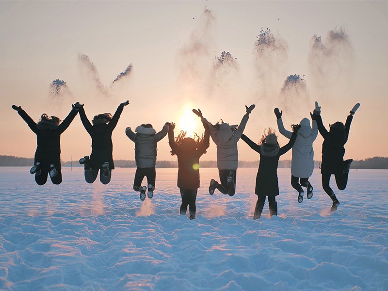 Life Extension, group of people jumping outside  on the snow on a sunny day